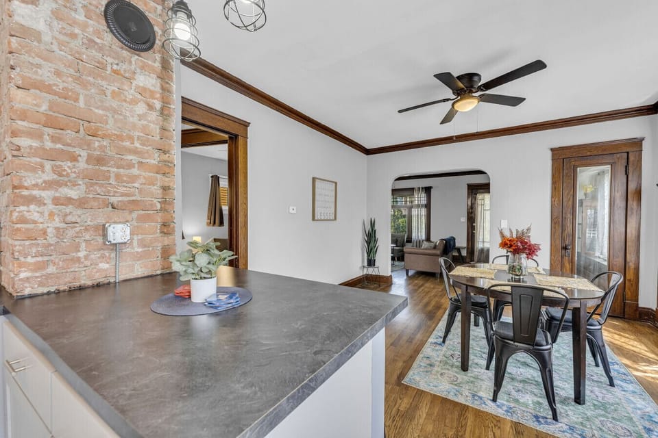 Cozy dining setup framed by brick & soft light for relaxed dinners.