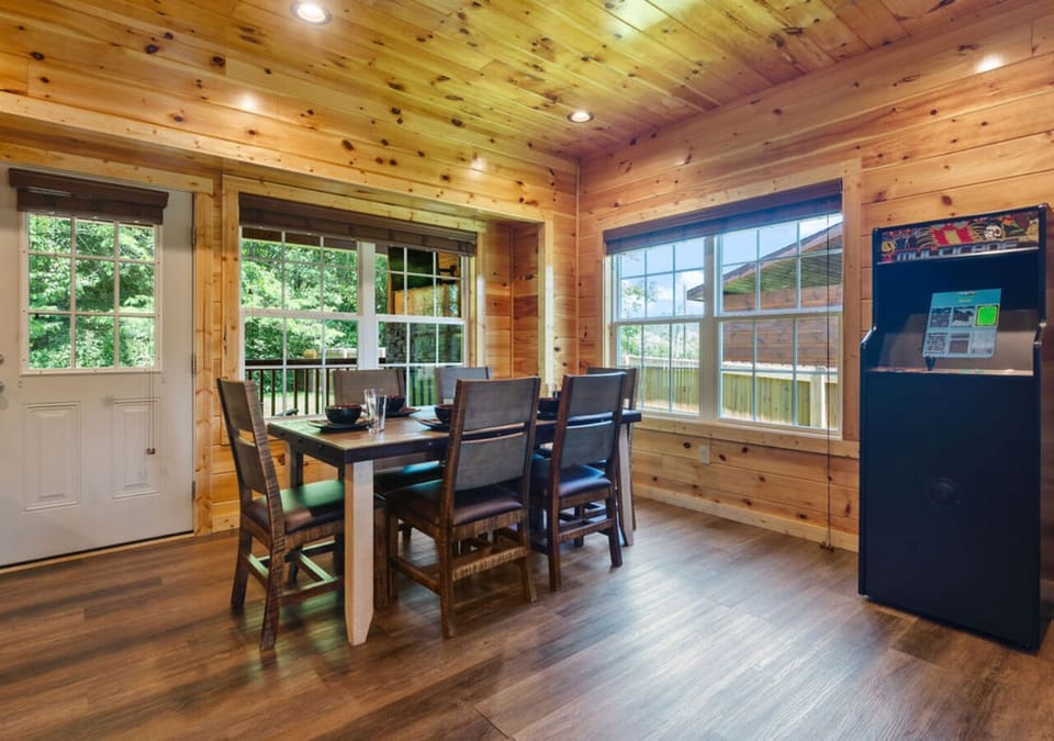 Cozy dining area with room for the whole family and scenic cabin views.