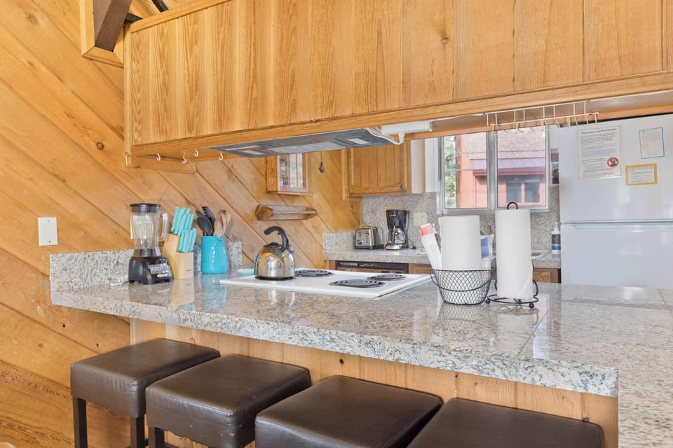 Open-concept dining room with table for 6 and bar seating.