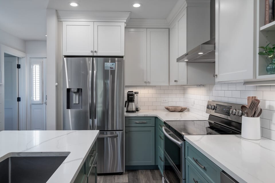 Well stocked kitchen with stainless steel appliances.