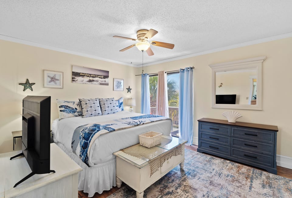 Primary bedroom features a king bed and a TV.