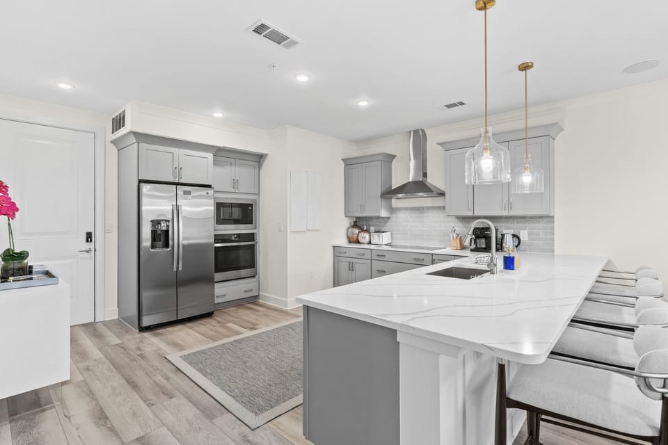 Fully equipped chef’s kitchen with stainless-steel appliances and a spacious breakfast bar.