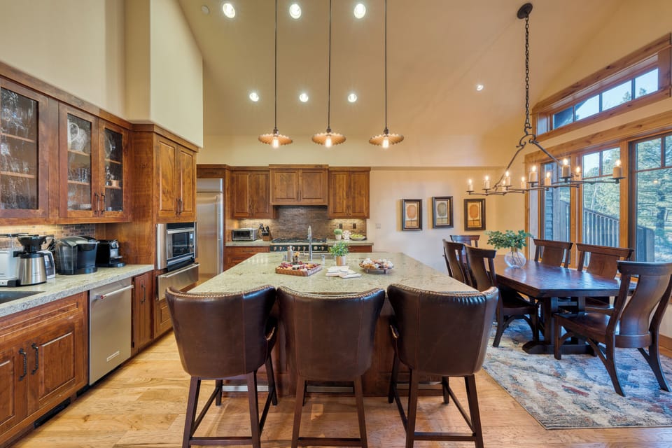 Spacious chef’s kitchen with a large island, stainless appliances, and dining for the whole group.
