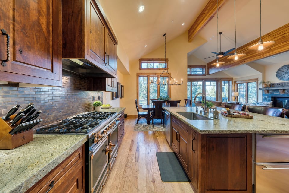 Spacious chef’s kitchen with a large island, stainless appliances, and dining for the whole group.