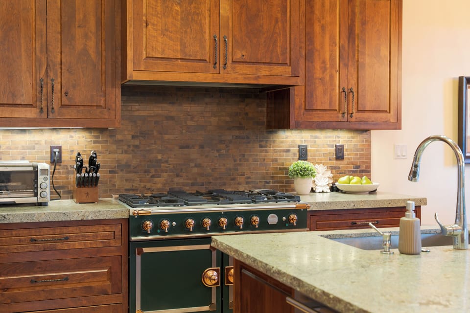 Spacious chef’s kitchen with a large island, stainless appliances, and dining for the whole group.