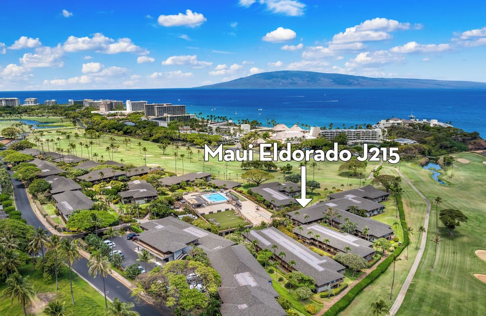 Aerial view of Maui Eldorado framed by lush golf course greens and shimmering ocean views