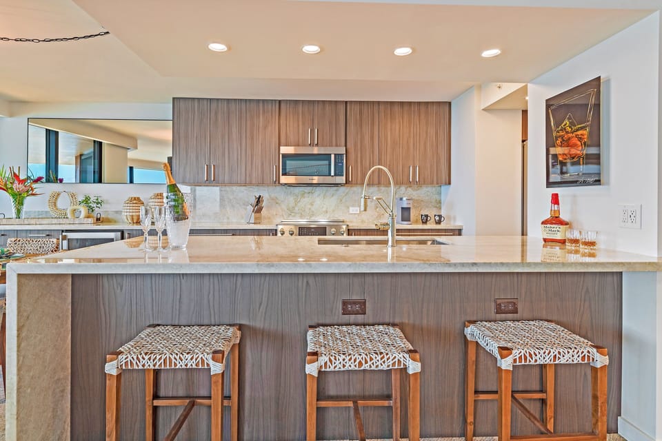 A large island with bar stools, perfect for quick meals or socializing while cooking