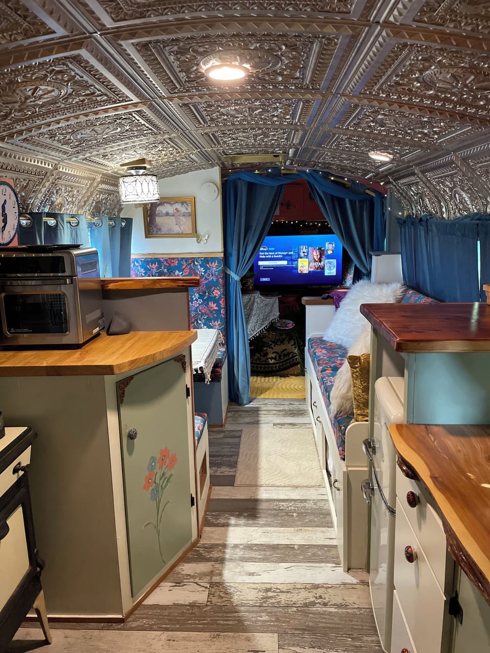 Front living area includes dinette and couch. View toward cab