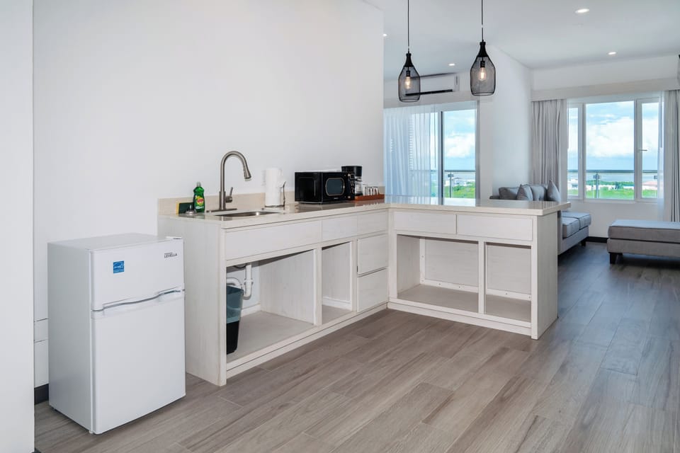 Mini kitchen area with mini fridge, sink, microwave