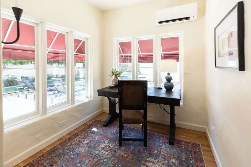 Dedicated workspace with separate a/c unit with stunning backyard/pool views. Spacious desk with an easy to access charging outlet.