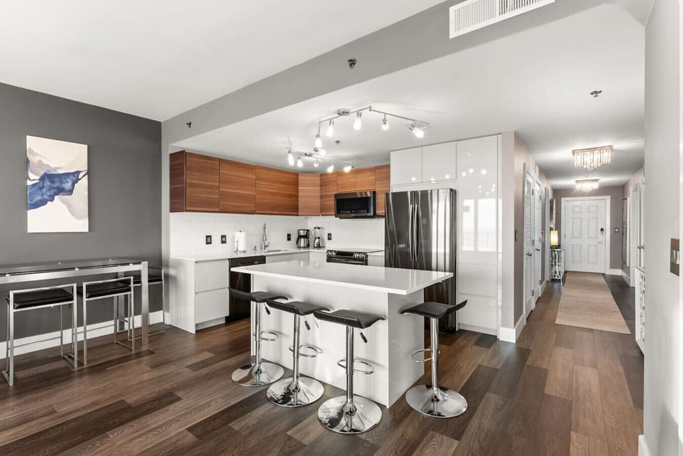 Kitchen + Island Seating – Sleek modern kitchen with large island and bar seating for effortless vacation dining.