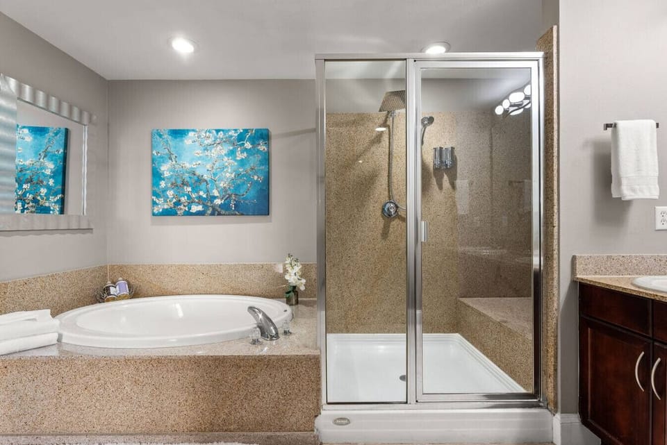 Master ensuite showcases a large soaking tub and separate glass-enclosed shower
