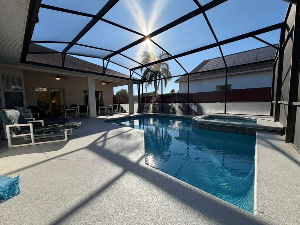Enjoy your own private screened-in pool and spa, perfect for relaxing after a day at the parks. The sunny deck, comfortable seating, and peaceful outdoor vibe create the ideal space for family fun, morning swims, or quiet evenings.