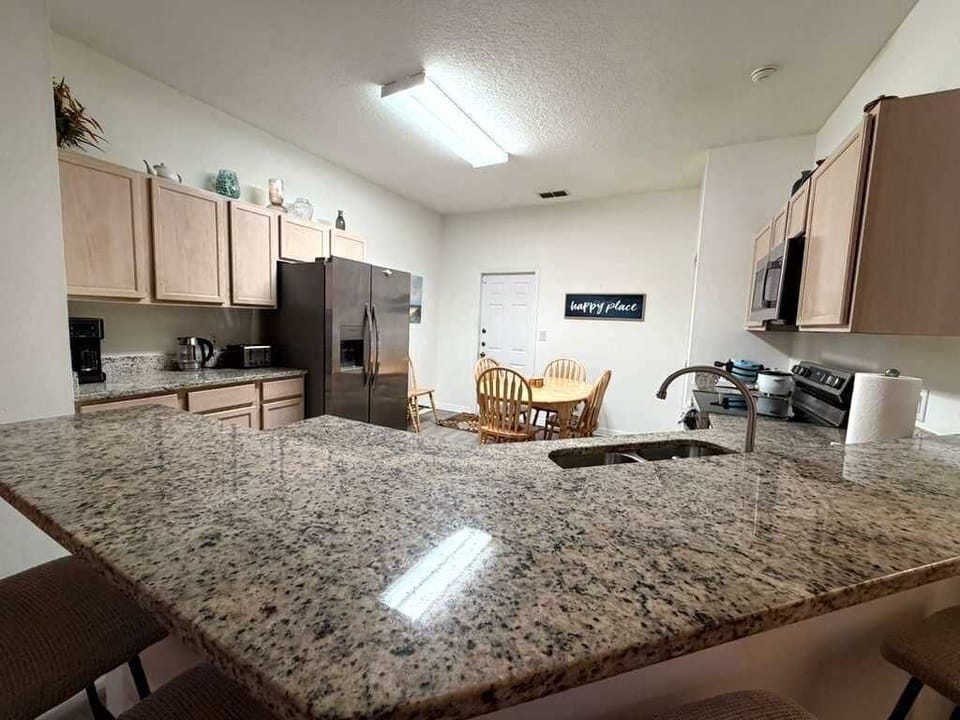 Enjoy this perfect blend of style and function in this modern kitchen, channel your inner chef using this sleek granite countertops and steel appliances. Whether you're brewing morning coffee or making a fancy dinner, this kitchen is ready for you!