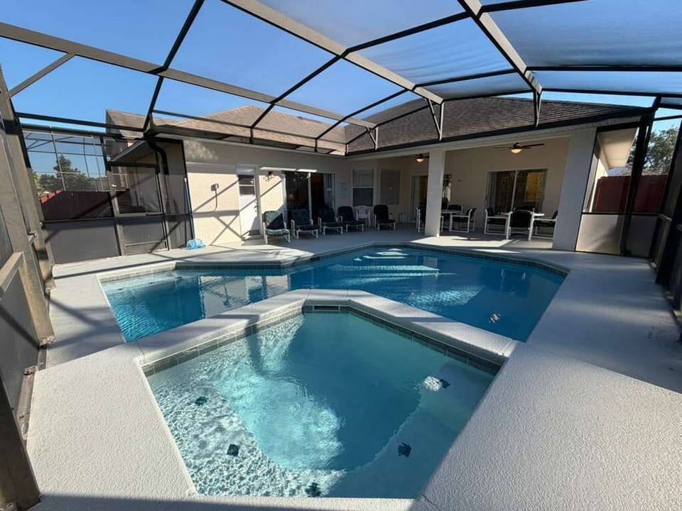 Enjoy your own private screened-in pool and spa, perfect for relaxing after a day at the parks. The sunny deck, comfortable seating, and peaceful outdoor vibe create the ideal space for family fun, morning swims, or quiet evenings.