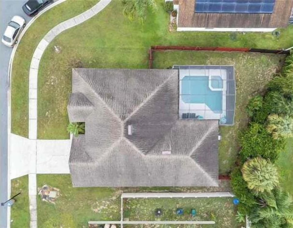 Enjoy total serenity in this expansive property where a pristine pool offer a quiet escape from the everyday hustle. This bird-eye view reveals a sprawling layout designed for outdoor gatherings and privacy under the sun.
