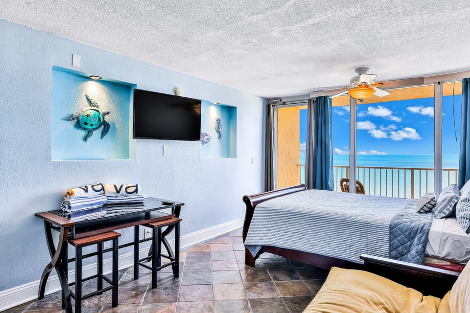 Relax in this oceanfront studio featuring a cozy bed, dining nook, and private balcony with sweeping beach views. Perfect for a memorable beach stay with coastal décor, ocean breezes, and easy access to sun and sand.