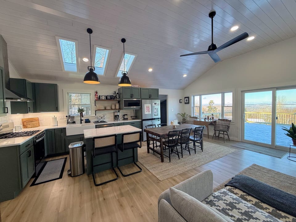 Modern open concept kitchen, living area and dining room with great views