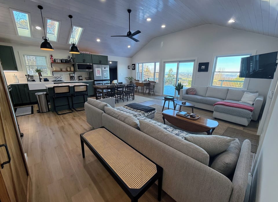 Modern open concept kitchen, living area and dining room with great views
