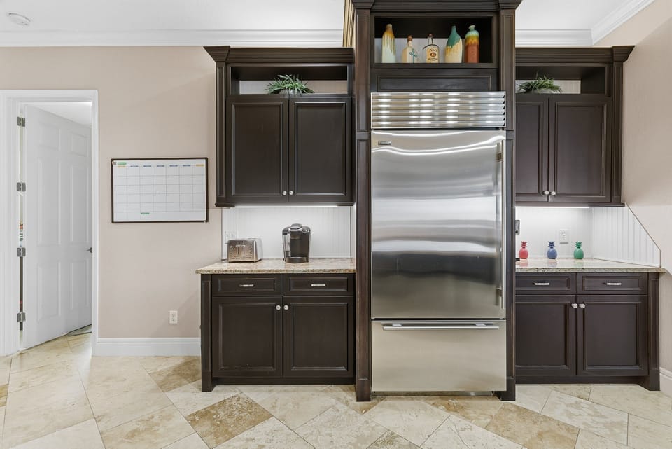 This well-appointed kitchen features ample cabinetry, stainless appliances, and plenty of prep space. Designed for easy meals and relaxed cooking during your beach stay, blending function with coastal style.