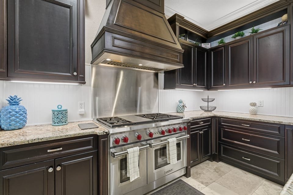 Cook like a pro in this gourmet kitchen featuring a professional gas range, custom cabinetry, and granite counters. Perfect for preparing fresh meals during your beach stay with ease and coastal style.