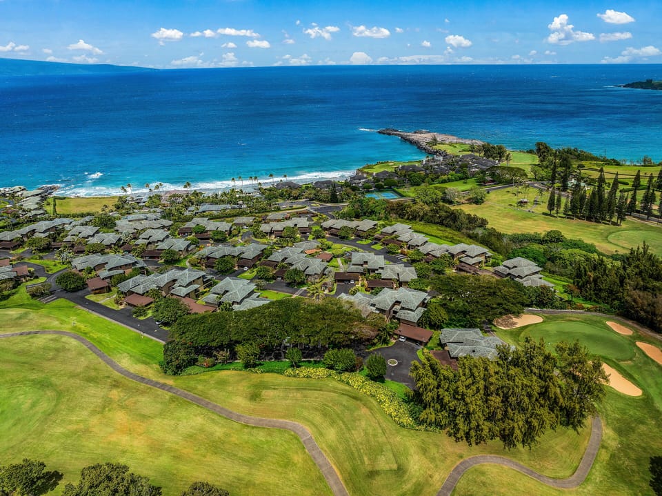 Admire panoramic aerial views of the resort grounds surrounded by lush greenery and sparkling blue waters.