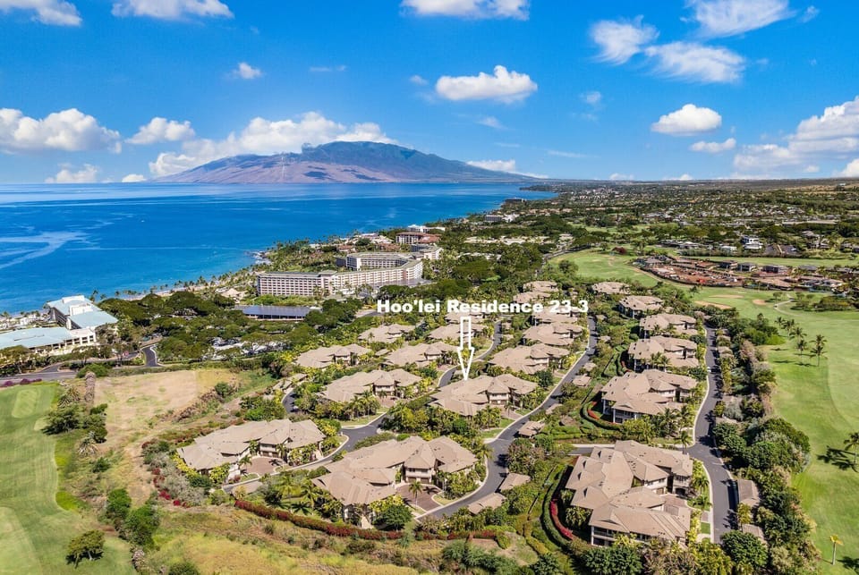 Stunning drone shot showcasing Ho'olei's lush landscaping, elegant villas, and proximity to the sparkling Pacific Ocean