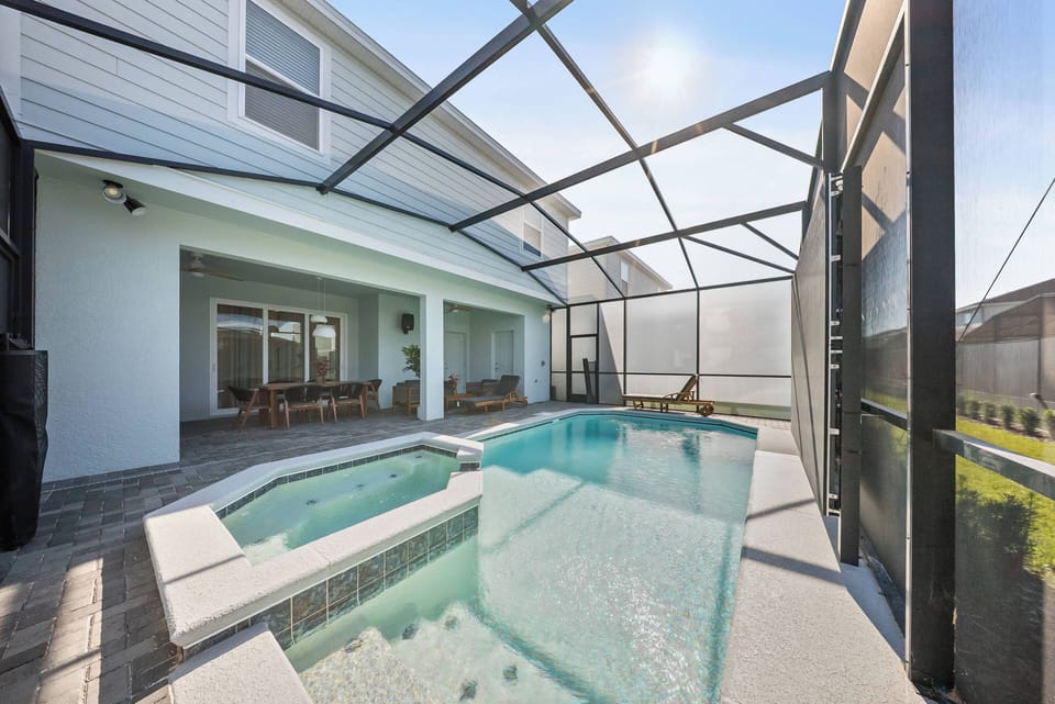 Step outside to your private oasis with a sparkling pool and screened enclosure, blending relaxation and comfort. The elegant stone deck enhances the airy atmosphere, inviting you to unwind in style.