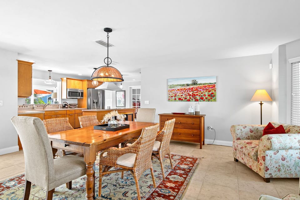 Step into your bright, open-concept retreat where the kitchen flows seamlessly into your dining and living spaces. You'll love preparing meals while staying connected to your group, then gathering around the beautiful wooden dining table for memorable conv
