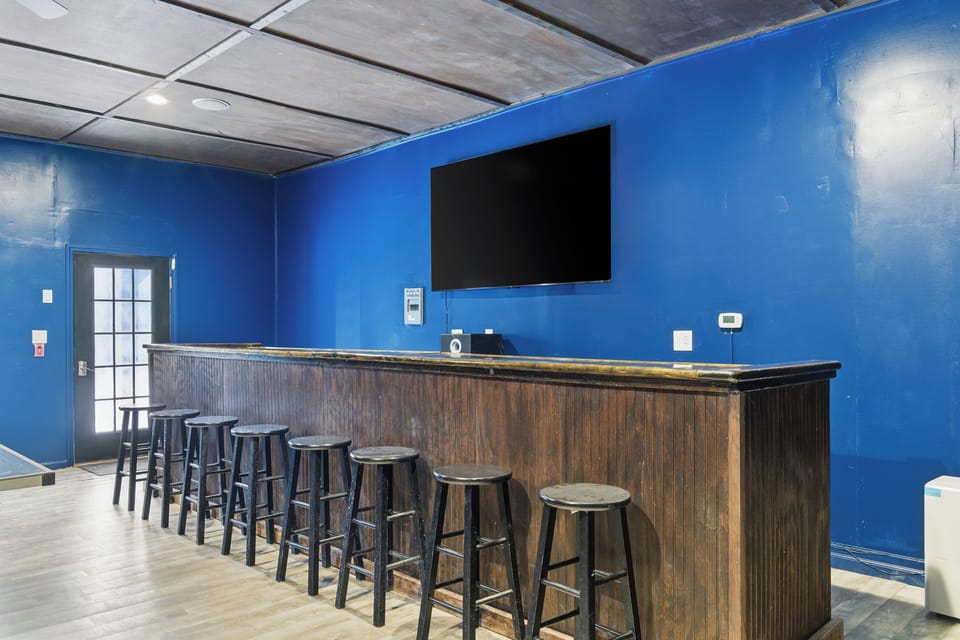 Game Room with Full Length Bar and 85 inch TV