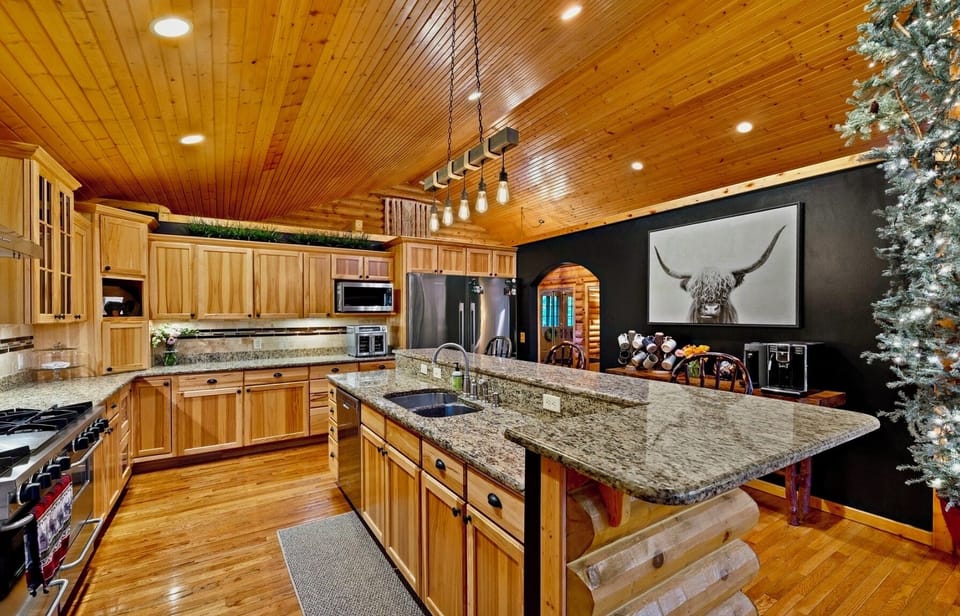 A Chef's kitchen with oversized counters and double refrigerators.