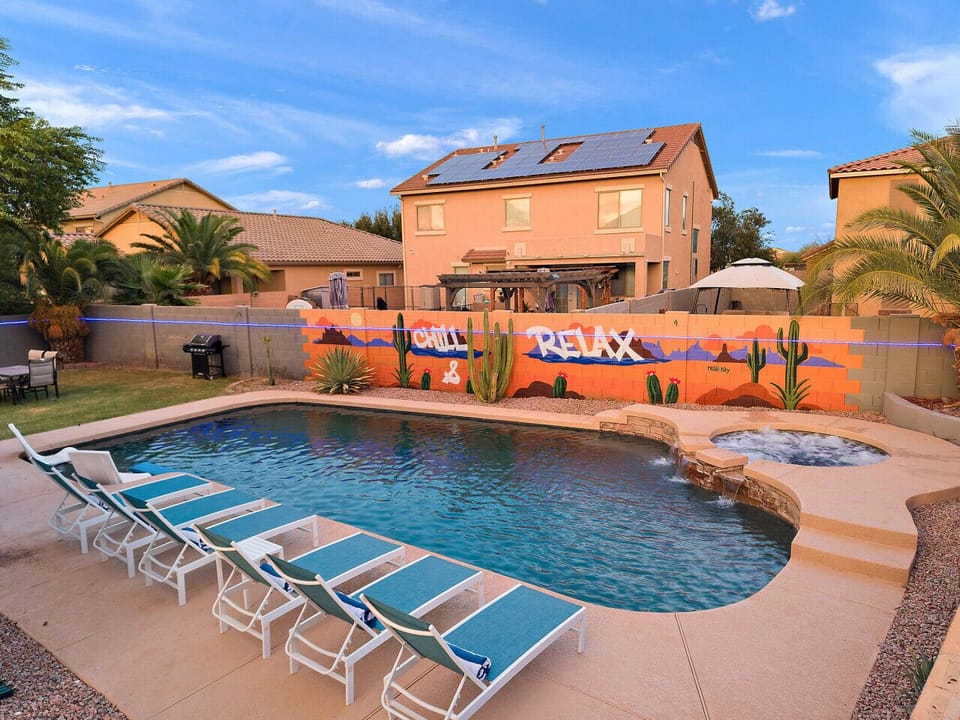“Spacious heated pool & spa with our signature CHILL & RELAX mural — your private resort-style backyard.”