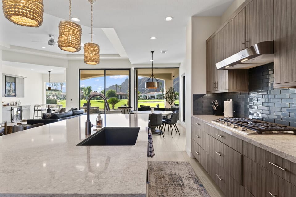 Modern kitchen w/ large island, sleek finishes & bar seating for casual dining