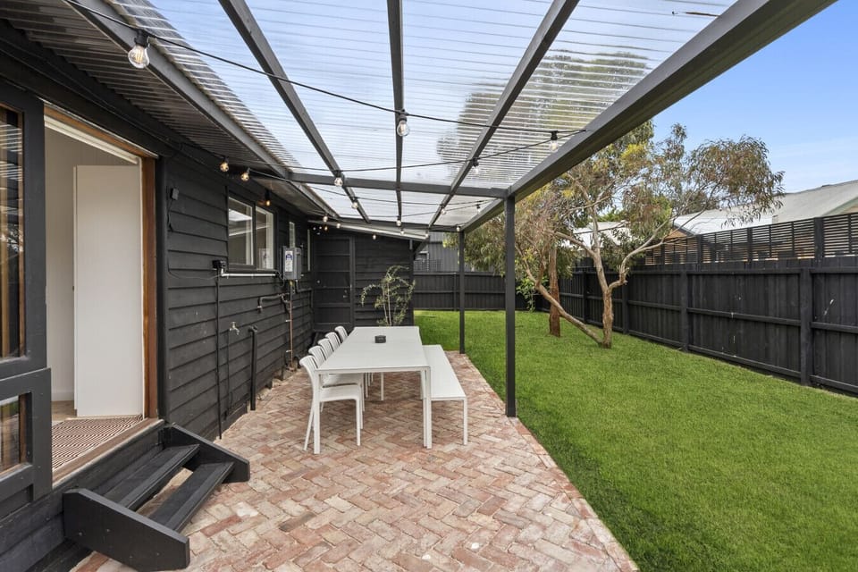 Outdoor dining area with lawn and covered seating