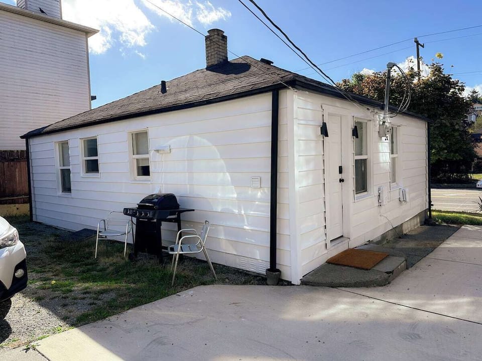 Rear of house for parking lot area and BBQ. 