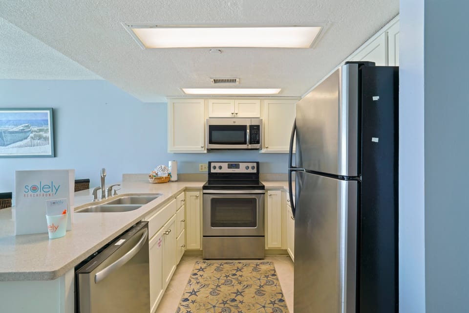 Cabana Club 304boasts a beautifully updated kitchen with stainless appliances, ample counter space, and seating for family gatherings.