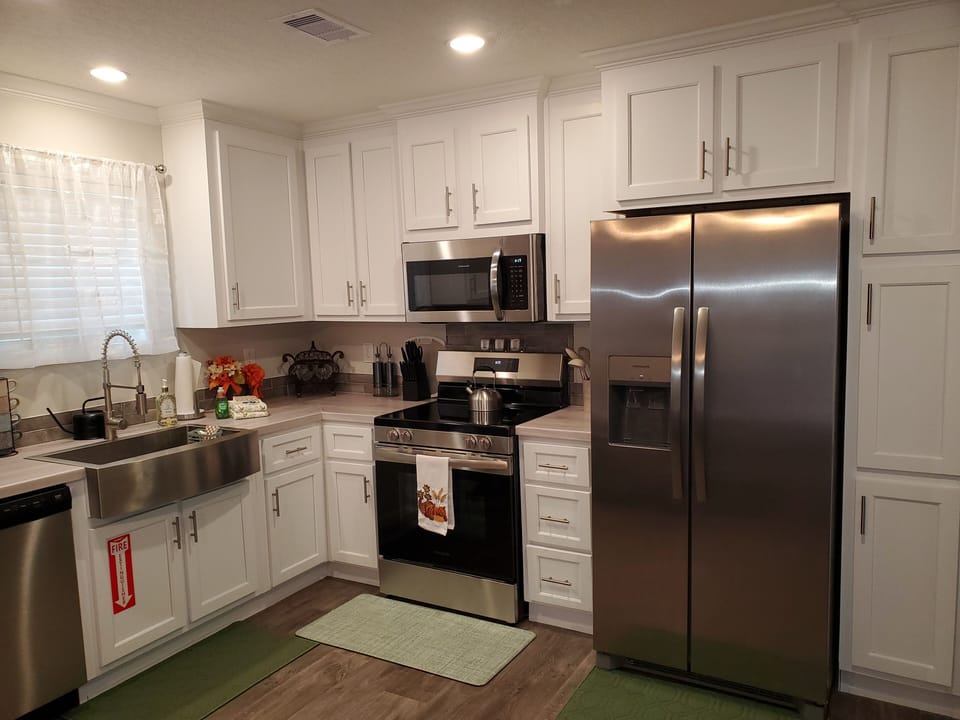 kitchen (trash can is located in the cabinet to the bottom right of the fridge)