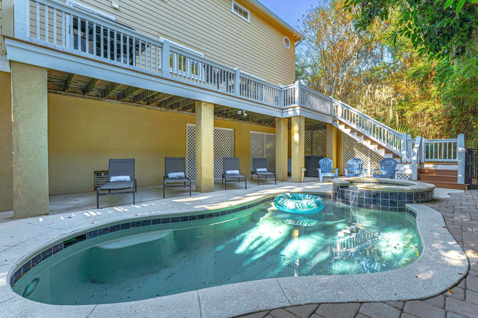 Large deck with multitude of sun loungers, Adirondack chairs, and comfortable seating areas