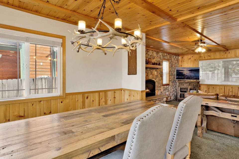 Stylish dining area with wood table, enhanced by soft ambient lighting