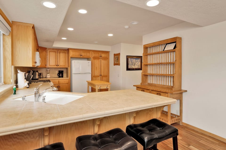 Fully equipped cabin kitchen with ample cabinetry, stove, fridge, microwave, and coffee maker—perfect for cooking meals, morning coffee, and feeling right at home on your stay.