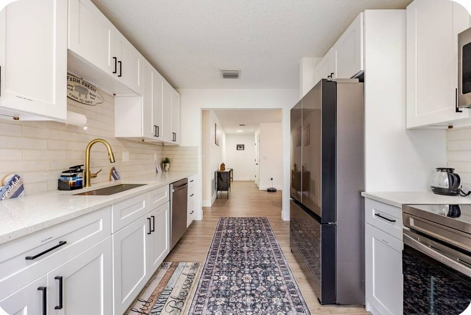 Full Sized Stove and Fridge with the Kitchen Flowing into Dining Area.