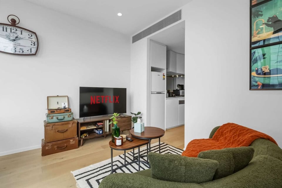 A vintage suitcase turntable with a vinyl record ready to play — a charming in-home touch that sets the mood for a relaxed evening in. Put on a record and let the city views do the rest.