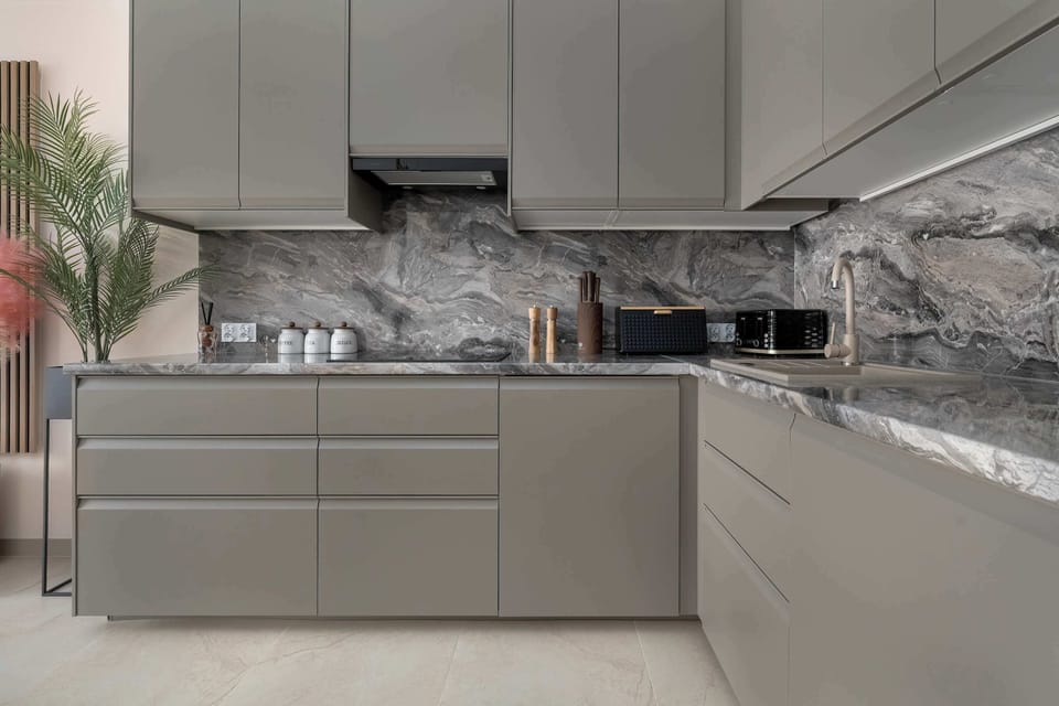 The sleek design of the kitchenette blending seamlessly with the living area.