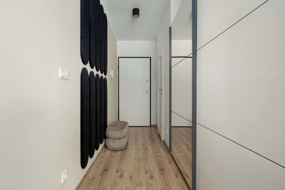 Hallway with built-in wardrobes and bright lighting.