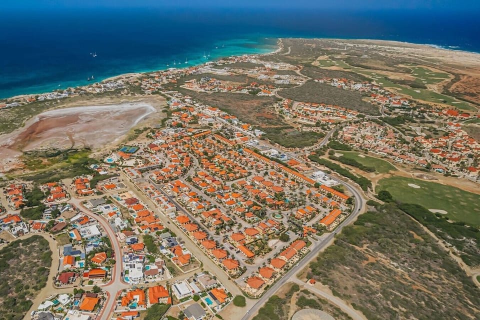 Aerial view of the Gold Coast Aruba resort, looking north west towards Malmok beach and the Tierra del Sol golf course. Guests enjoy access to resort-style amenities while staying close to Aruba’s beaches, dining and attractions.