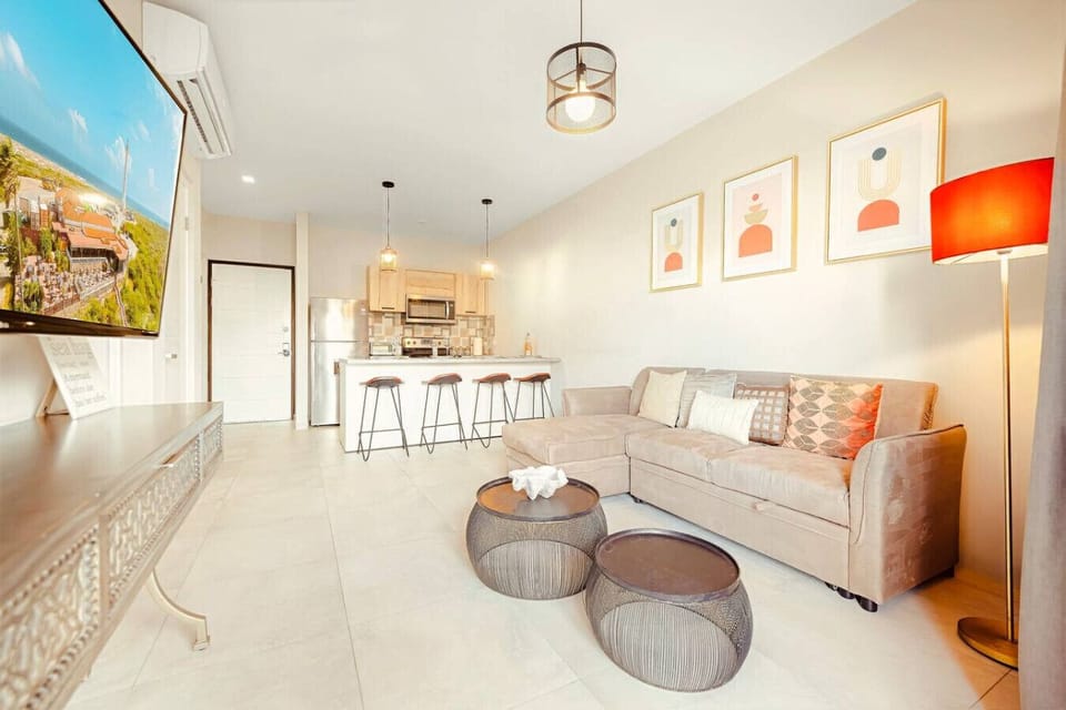 A bright, open living space where you can relax on the comfy sofa, enjoy a movie, or share meals together in the fully equipped kitchen just steps away.