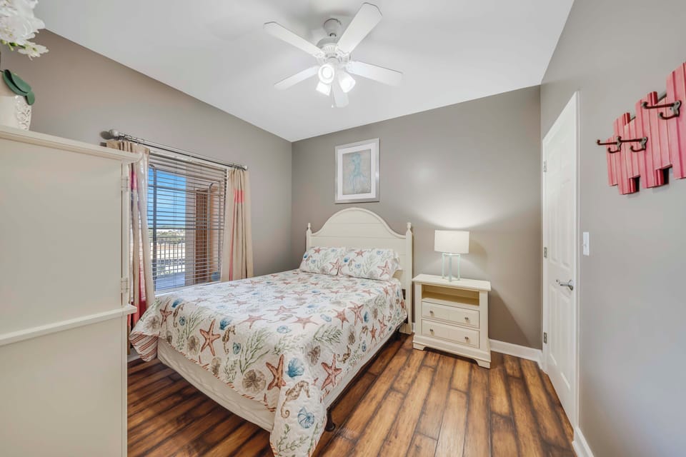 The second bedroom offers a Queen-sized bed and its own television.