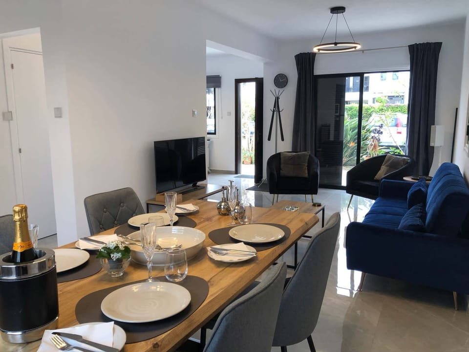 Open plan dining and living room leading to front garden and pool