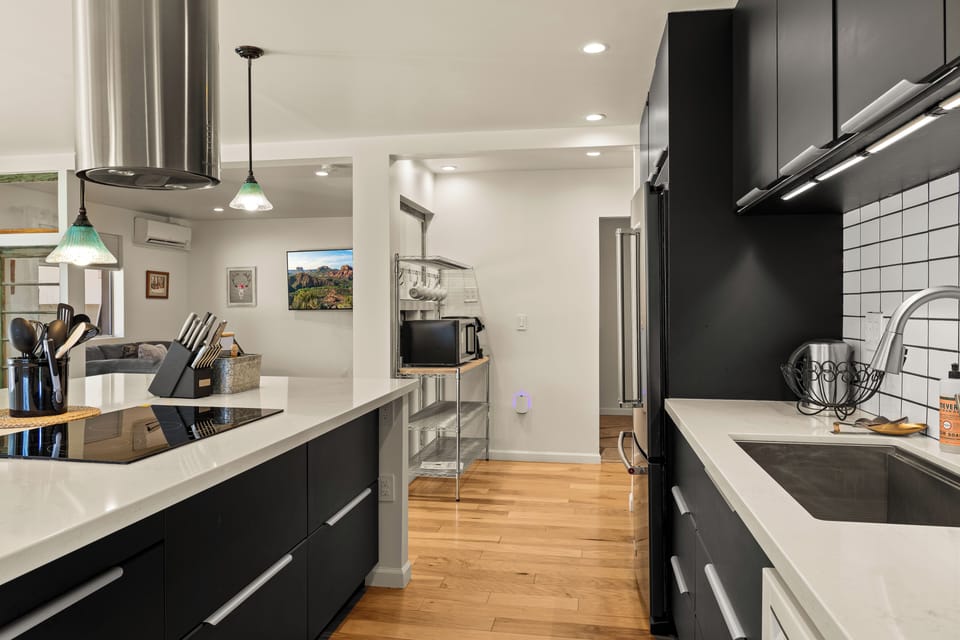Your modern kitchen awaits with sleek cabinetry, quartz counters, and stainless appliances—perfect for cooking up vacation memories in comfort and style.