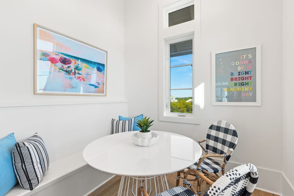 Settle into your bright dining nook where cheerful artwork and a cozy corner bench create the perfect spot for morning coffee or evening meals together.